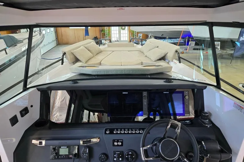 Slide: The Image of 2026 Axopar 29 XC Cross Cabin interior with modern dashboard and cushioned seating area. - 15