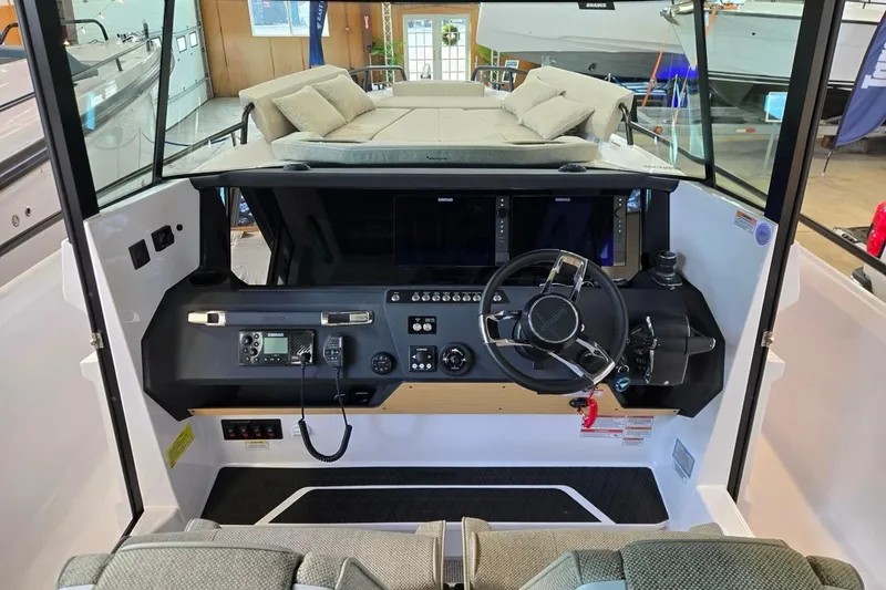 Slide: The Image of 2026 Axopar 29 XC Cross Cabin interior with modern helm and comfortable seating. - 16