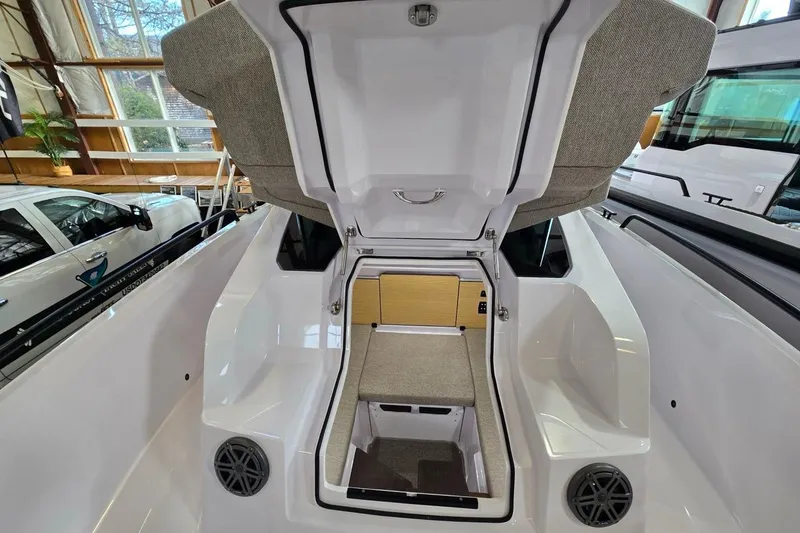 Slide: The Image of 2026 Axopar 29 XC Cross Cabin interior with open hatch, showcasing seating and storage. - 22