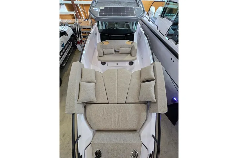 Slide: The Image of 2026 Axopar 29 XC Cross Cabin with beige seating and solar panel roof. - 30