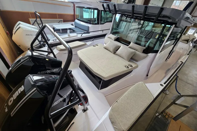 Slide: The Image of 2026 Axopar 29 XC Cross Cabin boat with Mercury engines in a showroom. - 34