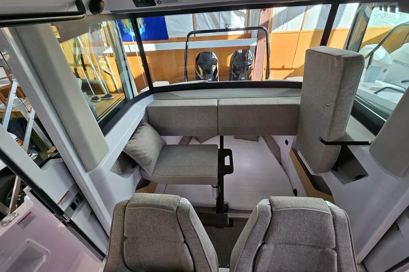 Slide: The Image of 2026 Axopar 29 XC Cross Cabin interior with modern seating and panoramic windows. - 35
