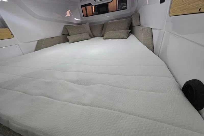 Slide: The Image of 2026 Axopar 29 XC Cross Cabin interior with cozy bed and cushions. - 37