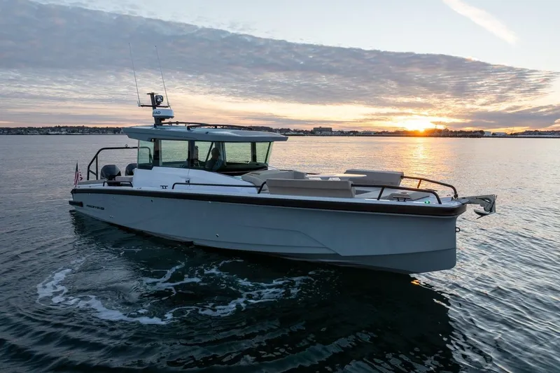 Slide: The Image of 2026 Axopar 29 XC Cross Cabin boat cruising at sunset on calm waters. - 4