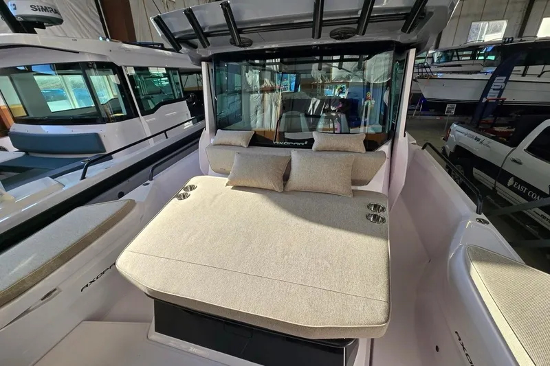 Slide: The Image of 2026 Axopar 29 XC Cross Cabin boat interior with cushioned seating and modern design. - 7