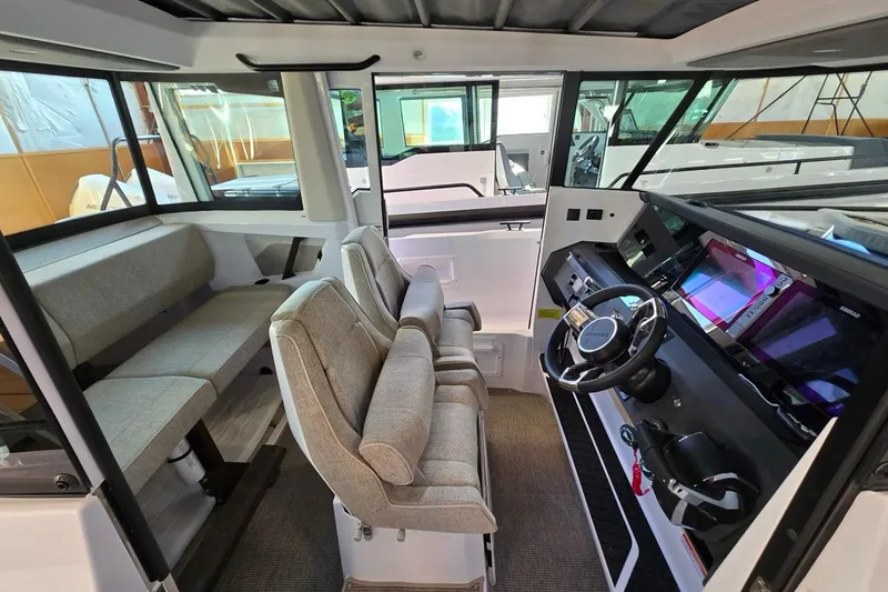 Slide: The Image of 2026 Axopar 29 XC Cross Cabin interior with modern helm and seating. - 9
