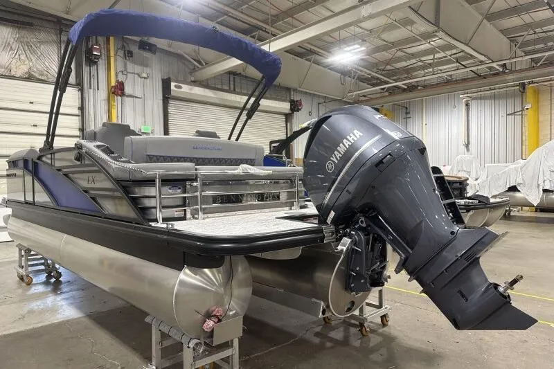 Slide: The Image of 2026 Bennington 23 LXS Swingback pontoon boat with Yamaha outboard motor in a warehouse. - 13