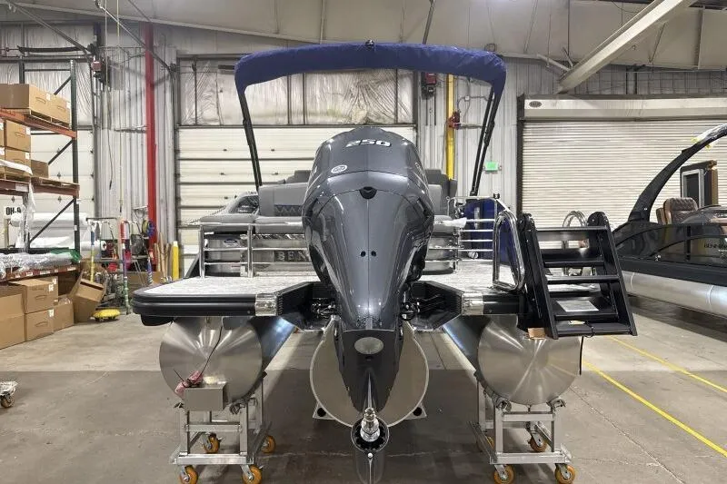 Slide: The Image of 2026 Bennington 23 LXS Swingback pontoon boat in a warehouse setting. - 14