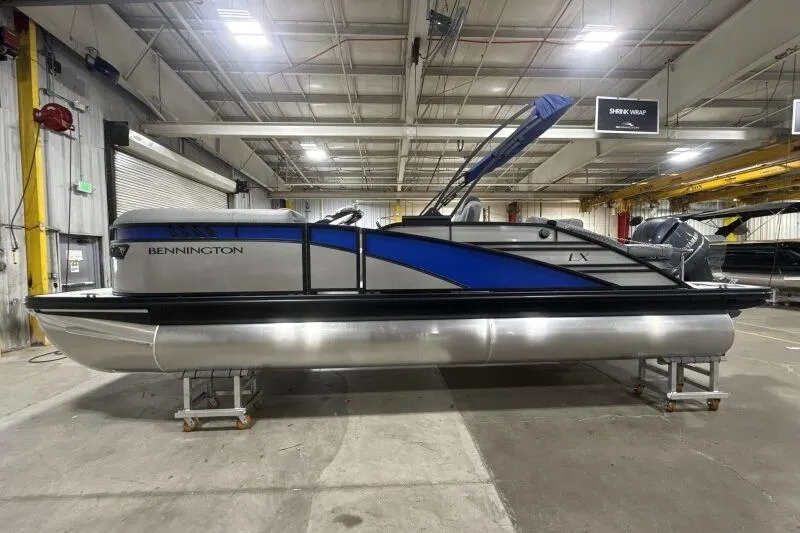 Slide: The Image of 2026 Bennington 23 LXS Swingback pontoon boat in a warehouse setting. - 3