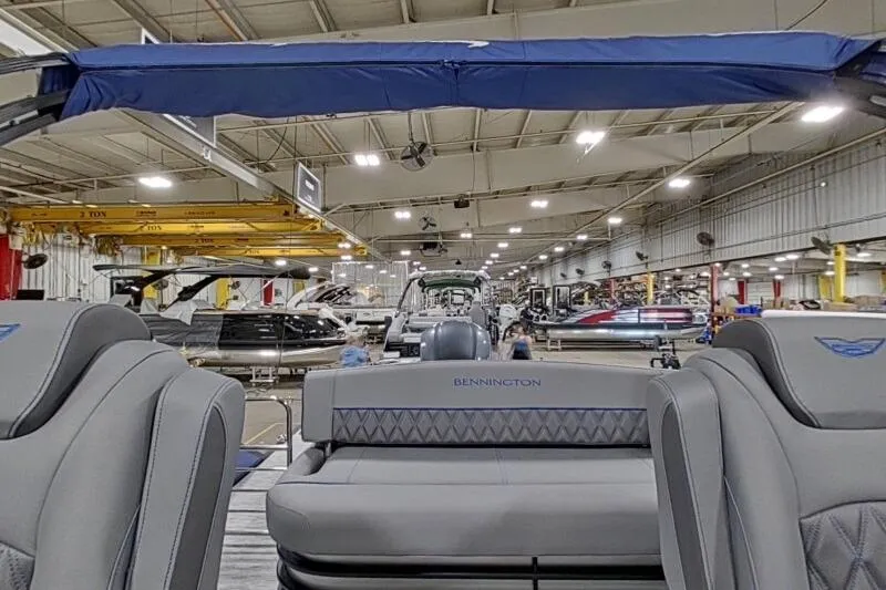 Slide: The Image of 2026 Bennington 23 LXS Swingback boat interior in a manufacturing facility. - 4