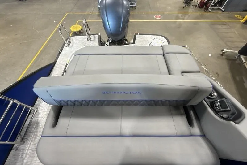 Slide: The Image of 2026 Bennington 23 LXS Swingback boat interior with gray seating and motor view. - 8