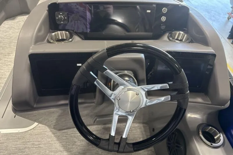 Slide: The Image of Steering console of 2026 Bennington 23 LXS Swingback with modern controls and cup holders. - 9