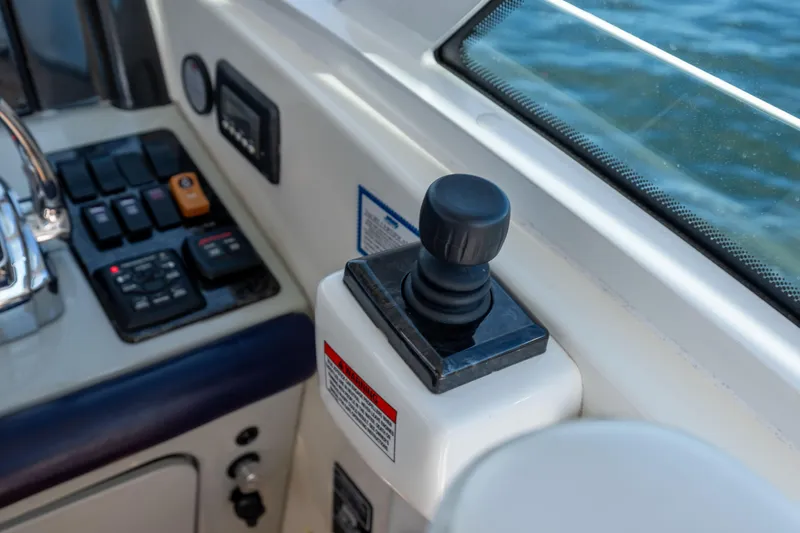 Slide: The Image of Control panel of a 2010 Sea Ray 500 Sundancer yacht with joystick and switches. - 14
