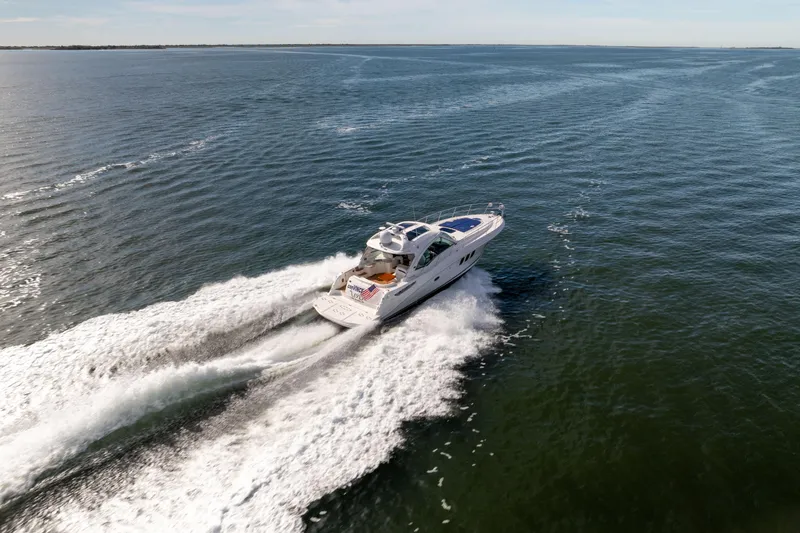 Slide: The Image of Aerial view of 2010 Sea Ray 500 Sundancer yacht cruising on open water. - 2