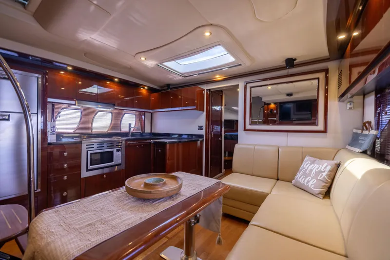 Slide: The Image of Luxurious interior of 2010 Sea Ray 500 Sundancer yacht with modern kitchen and cozy seating area. - 31