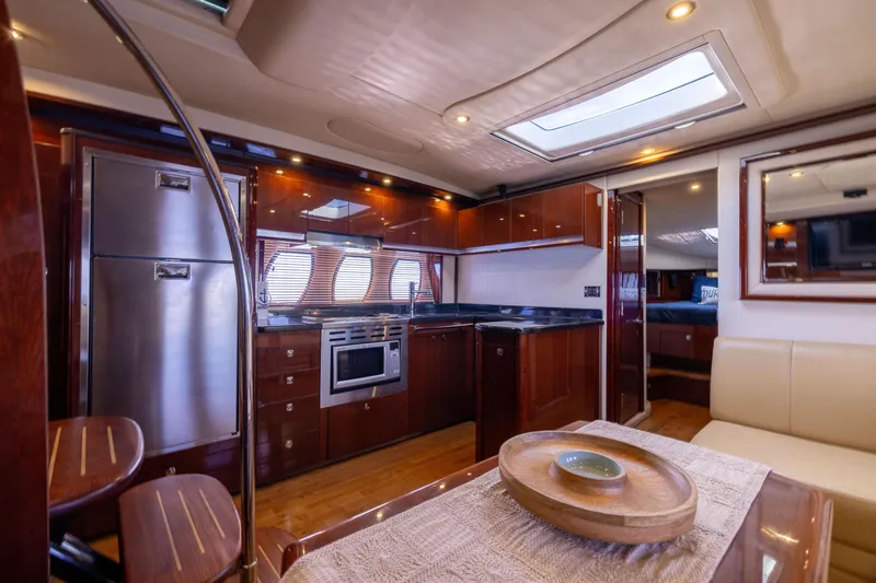 Slide: The Image of Luxurious interior of 2010 Sea Ray 500 Sundancer yacht with modern kitchen amenities. - 33
