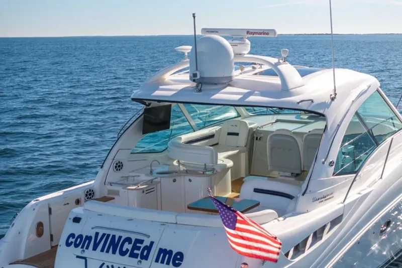 Slide: The Image of 2010 Sea Ray 500 Sundancer yacht cruising on open water with American flag. - 39