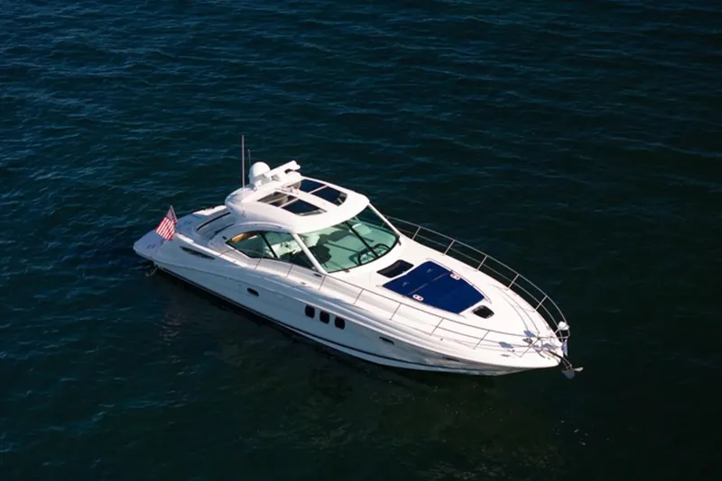 Slide: The Image of 2010 Sea Ray 500 Sundancer yacht cruising on open water. - 4