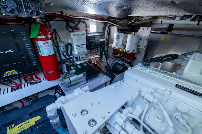 Slide: The Image of Engine room of a 2010 Sea Ray 500 Sundancer with mechanical components and wiring. - 47