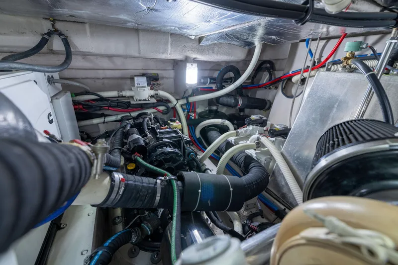 Slide: The Image of Engine room of 2010 Sea Ray 500 Sundancer with complex piping and machinery. - 49