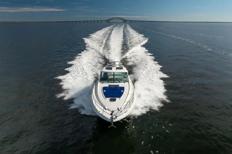 Slide: The Image of 2010 Sea Ray 500 Sundancer cruising on open water, leaving a wake behind. - 5