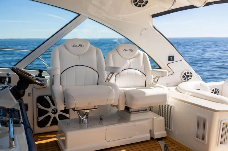 Slide: The Image of Luxurious 2010 Sea Ray 500 Sundancer cockpit with plush white seating and ocean view. - 9