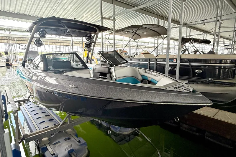Slide: The Image of 2016 Malibu Wakesetter 25 LSV boat docked in a covered marina. - 17