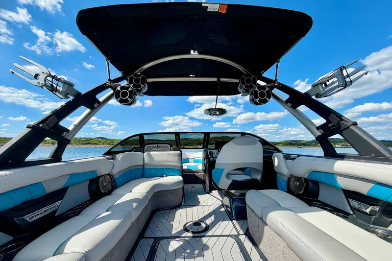 Slide: The Image of 2016 Malibu Wakesetter 25 LSV interior with luxury seating and sound system on a sunny day. - 24