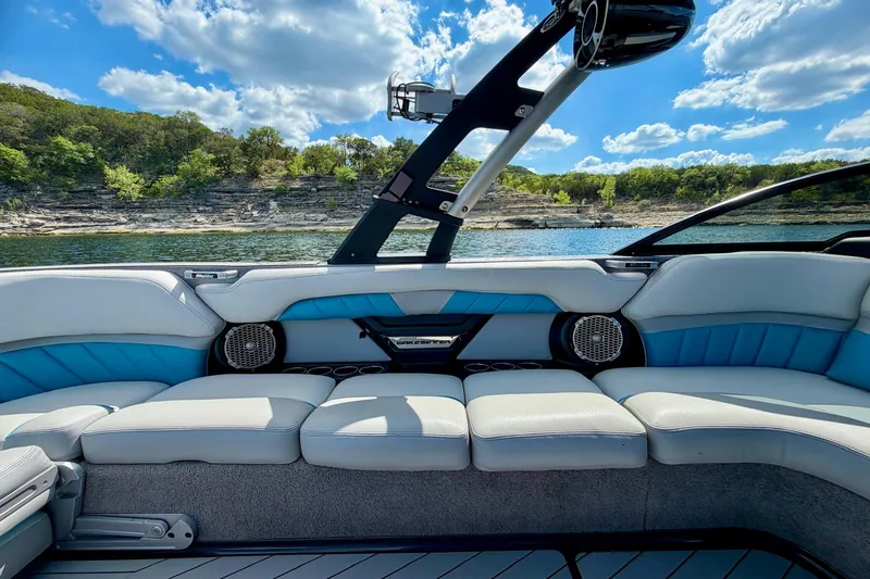 Slide: The Image of Interior of a 2016 Malibu Wakesetter 25 LSV boat with plush seating and scenic lake view. - 27