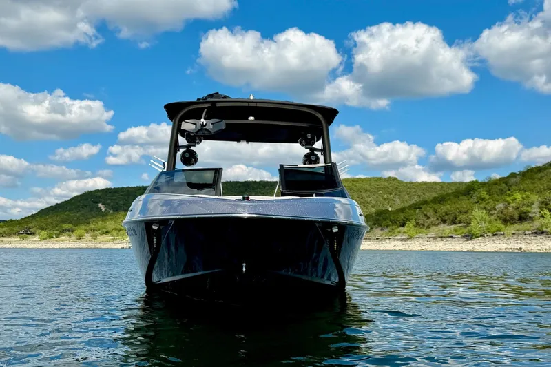 Slide: The Image of 2016 Malibu Wakesetter 25 LSV on a scenic lake with blue sky and clouds. - 9