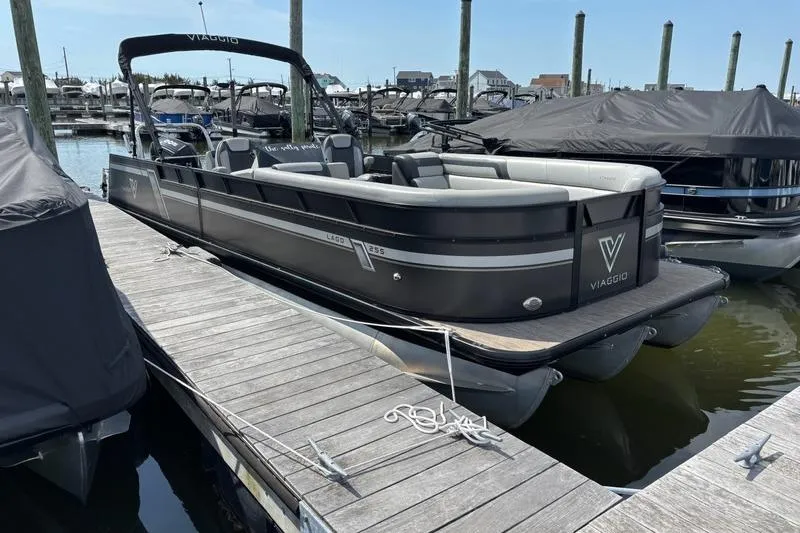 Slide: The Image of 2023 Viaggio LAGO 25S pontoon boat docked at marina. - 3