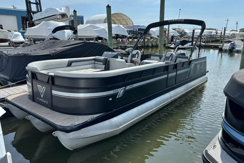 Slide: The Image of 2023 Viaggio LAGO 25S pontoon boat docked at marina. - 4