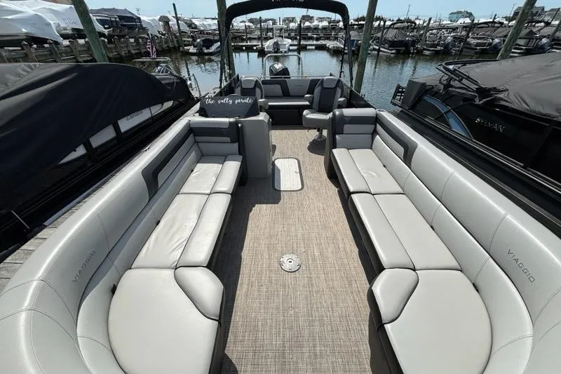 Slide: The Image of Luxurious 2023 Viaggio LAGO 25S pontoon boat with spacious seating at marina. - 5
