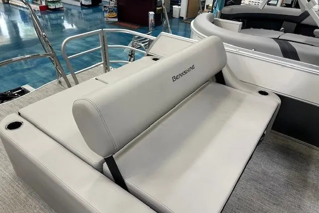 The Image of 2026 Berkshire 24UL LE B boat interior with beige seating and cup holders. - 1