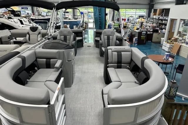 Slide: The Image of 2026 Berkshire 24UL LE B pontoon boat with spacious seating in showroom. - 11