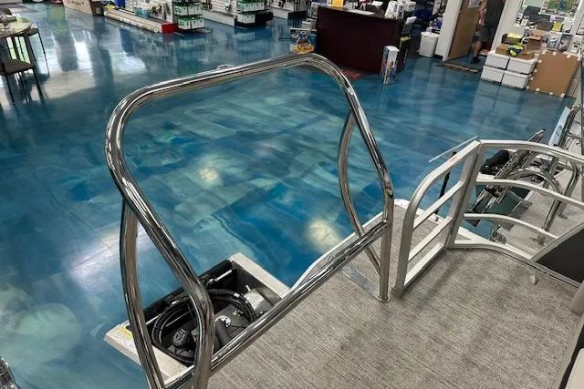 Slide: The Image of 2026 Berkshire 24UL LE B boat interior with polished metal railings and blue flooring. - 3