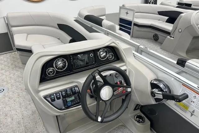 Slide: The Image of 2026 Berkshire 24UL LE B pontoon boat interior with modern steering console and seating. - 4