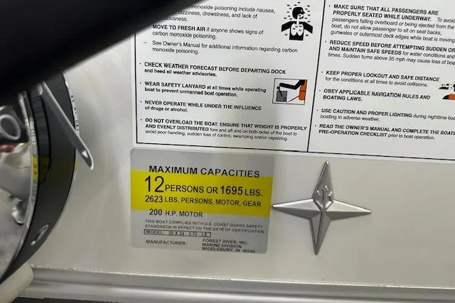 Slide: The Image of 2026 Berkshire 24UL LE B boat capacity label, 12 persons or 1695 lbs, 200 HP motor. - 5