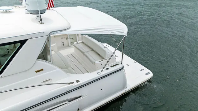 Slide: The Image of Interior view of a 2004 Tiara 3800 boat with rod holders and American flag. - 11