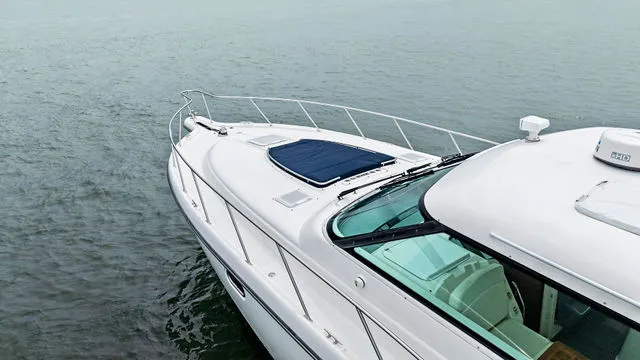 Slide: The Image of Luxury seating area on a 2004 Tiara 3800 yacht with a polished wooden table. - 12