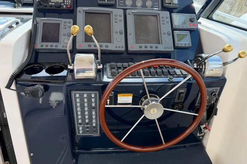 Slide: The Image of Control panel of a 2004 Tiara 3800 boat with steering wheel and navigation instruments. - 18