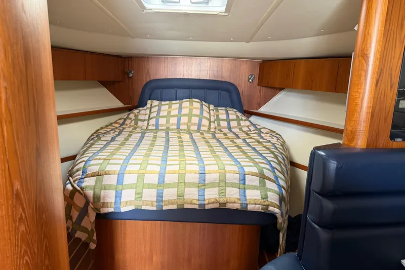 Slide: The Image of Cozy cabin interior of 2004 Tiara 3800 yacht with a patterned bedspread. - 19