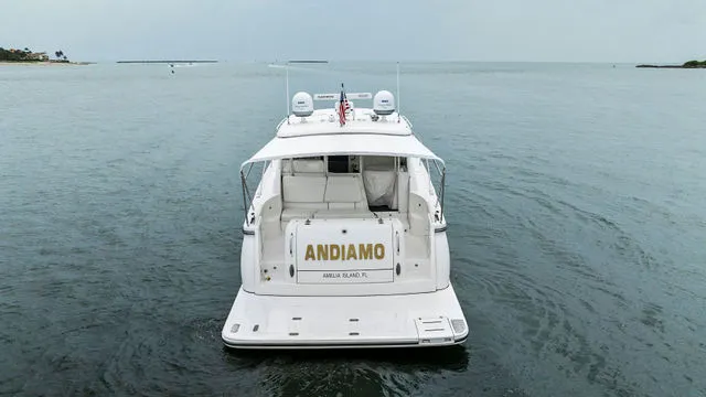 Slide: The Image of 2004 Tiara 3800 yacht interior with white seating and cooler on deck. - 2