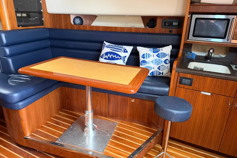 Slide: The Image of Luxurious 2004 Tiara 3800 yacht interior with dining area and kitchenette. - 20