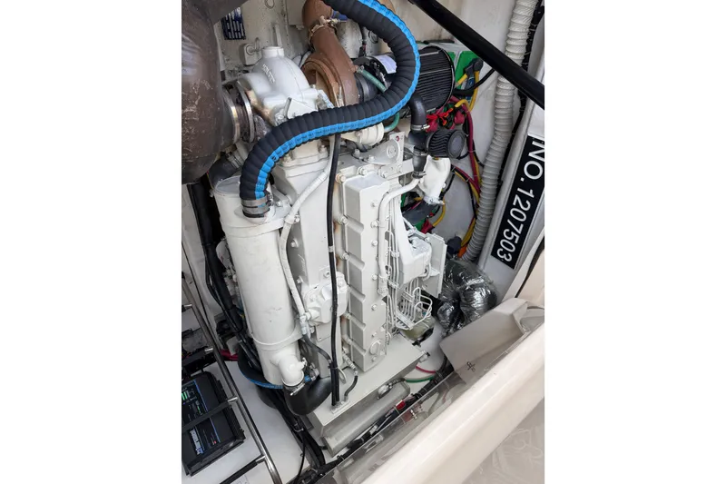 Slide: The Image of Engine compartment of a 2004 Tiara 3800 boat, showcasing detailed mechanical components. - 27