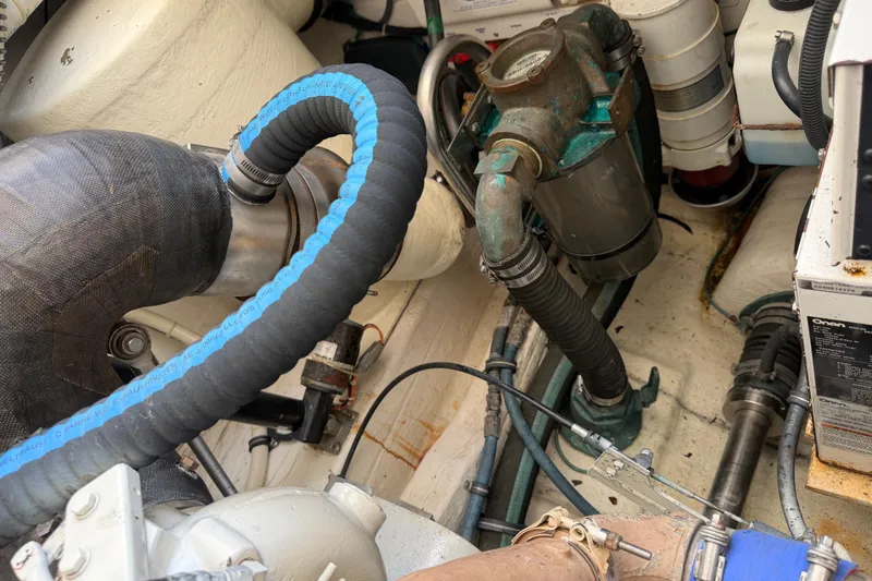 Slide: The Image of Engine compartment of a 2004 Tiara 3800 boat, showcasing hoses and mechanical components. - 30