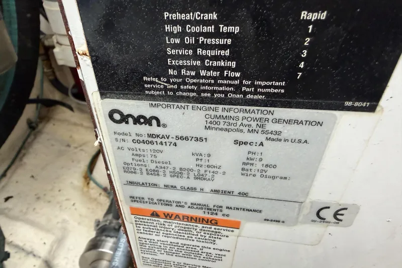 Slide: The Image of Label on Onan generator, model MDKAV-5667351, showing specifications and warnings. - 35