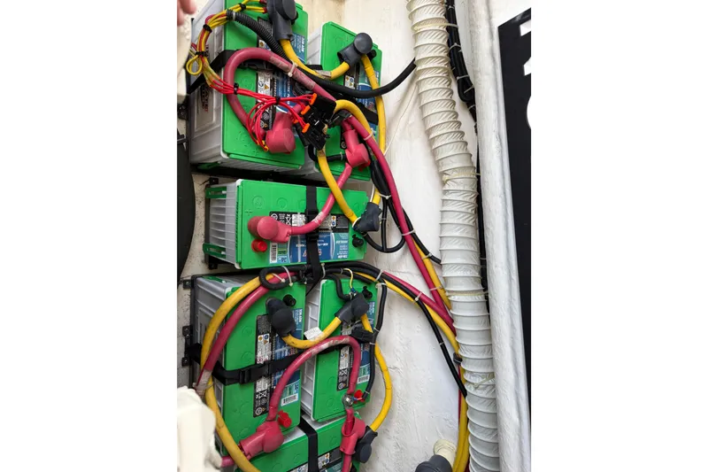 Slide: The Image of Battery setup with colorful cables in a 2004 Tiara 3800 boat. - 36
