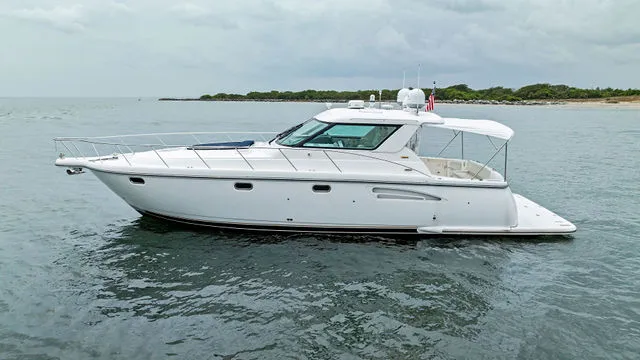 Slide: The Image of 2004 Tiara 3800 yacht docked, showcasing sleek design and spacious deck. - 9