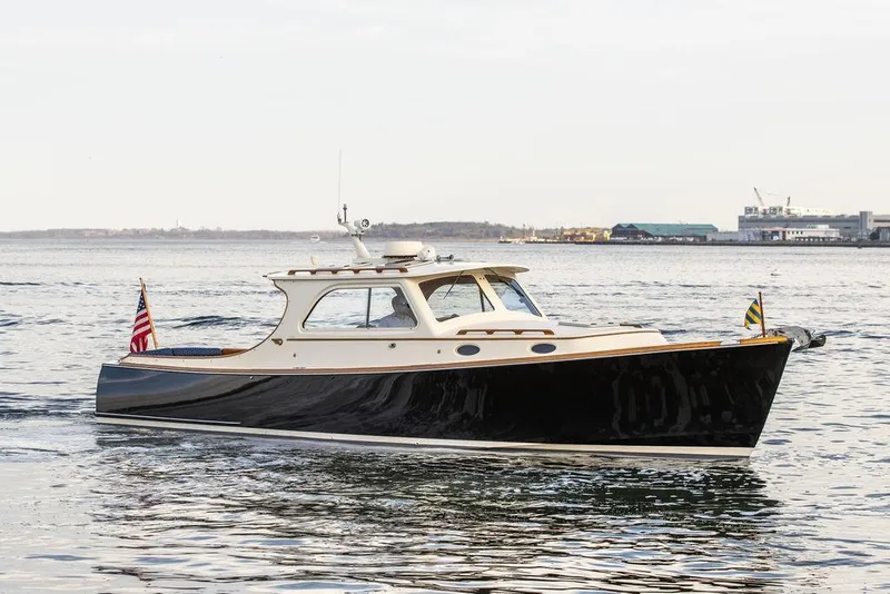 The Image of 2002 Hinckley Picnic Boat 36 EP cruising on calm waters. - 0